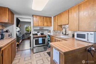 The kitchen with small eat in bar area and a galley dining space to sit down and enjoy a meal.