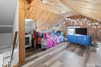 The second bedroom upstairs is spacious and lined in cedar.