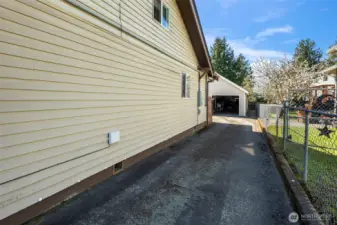 Long paved driveway runs on the North side of the home and connects to the detached garage.