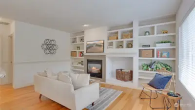 Continuing further in you will find a cozy living room with built-ins & gas fireplace, perfect for a movie night!
