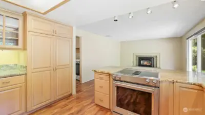 Ample cabinetry space for storage and neutral flooring that run through the kitchen and family room.