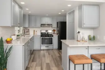 Beautifully renovated kitchen with new flooring, counters, tile and a fresh coat of paint.