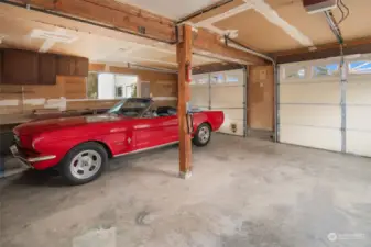 The attached 2-car garage has oodles of storage space along with a workbench.