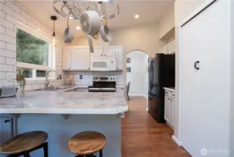 Belly up to the bar as your favorite chef prepares the perfect meal! Loads of counter space & updated lighting are nice features that this charming kitchen offers.