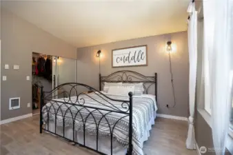 Another view of primary bedroom with vaulted ceilings and ample sized closet.