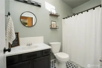 Upper level full bathroom with skylight - refreshed flooring, tile backsplash and paint.