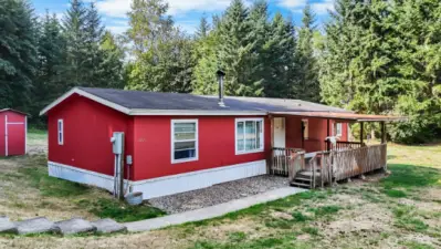 Beautiful double-wide on large lot with covered porch.