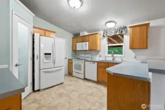 Light and bright kitchen with eating bar.