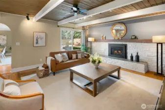 Living room features new carpet, hardwoods, gas fireplace, and built-in shelving which remains.