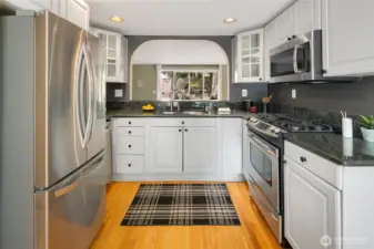 Updated kitchen with granite counters, stainless appliances with an abundance of cabintes.