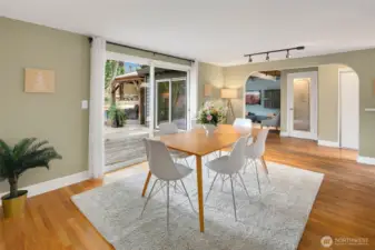 Formal dining with breakfast bar to the kitchen and sliding doors to the backyard deck.