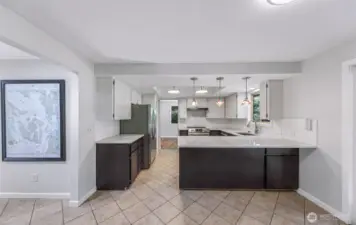 Kitchen with eating bar, new lighting, counters,sink and tiled floors