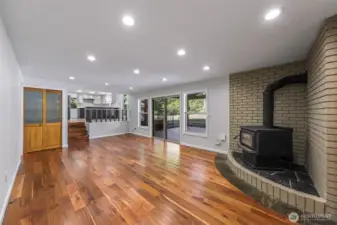 Lower level living room with stunning flooring, real wood stove, access to garage and Chalet covered back patio