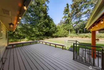 New Synthetic decking surrounded with benches looking out over the huge private back yard
