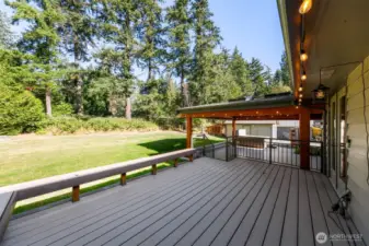GRAND chalet style covered patio with stained concrete, skylights and powered lights and plugs next to the large hot tub