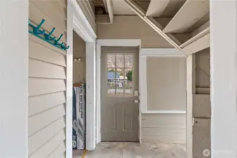 Backdoor with utility room on the left. Going right takes you to the stairs to the partially finished attic.