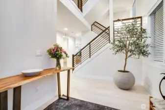 Grand entry - In the foyer, vaulted 3 story ceilings and grand staircase with wrought iron.