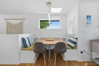 There is a large built in dining table nook right next to the kitchen.