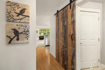 Entry foyer with sliding barn door to full size laundry room.