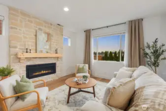 From this perspective, the living room showcases its spacious layout and cozy fireplace focal point, creating a warm atmosphere ideal for relaxing evenings or hosting guests.