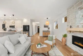 The main living area opens directly to the kitchen, creating a true open-concept layout ideal for everyday living and entertaining. Large windows bring in natural light while the expansive sightlines connect the gathering spaces throughout the main floor.