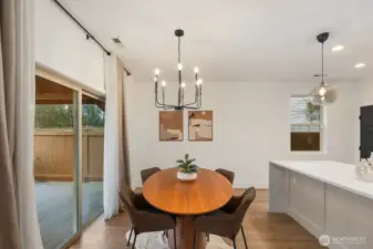 Dedicated dining area positioned beside large sliding glass doors that open to the backyard, creating effortless indoor-outdoor flow. This space is perfect for everyday meals or hosting guests with easy access to the kitchen and outdoor deck.