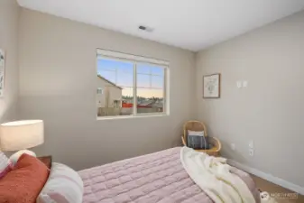 From this angle, the bedroom highlights its clean layout and warm, neutral tones that make the space feel bright and inviting. Natural light and simple styling create a peaceful setting for rest and relaxation.