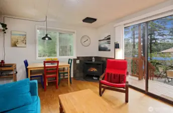 Cabin - Living room. Propane fireplace, dining space, slider out to deck and patio.