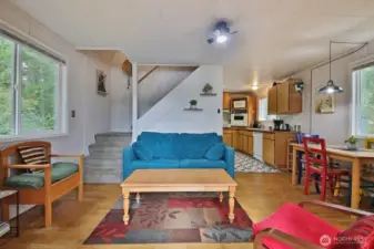 Canin -Living room. Stairs up to two guest rooms.