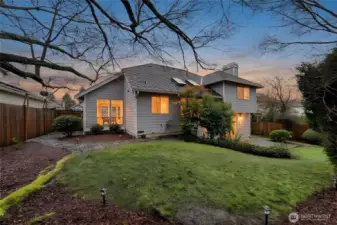 Sweeping view of fully fenced backyard.