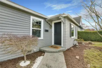 A covered front porch offers a simple, welcoming entry—let’s take a look inside.