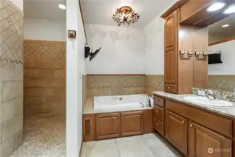 Private Toilet Area with Heated Floor, His and Hers sinks complete with Upright Cabinets. Upright Cabinets include Electric Outlets inside for Electric Razor and Toothbrush Charging, Vanity Area with full wall mirror and  Granite Countertops.