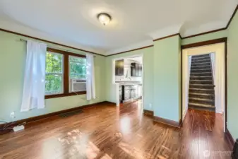 The dining room. A/C window unit stays. Notice the ceilings. The have great  craftmanship with arcs.