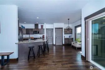 The kitchen bar provides additional seating while showcasing a well-designed layout with a convenient pantry and ample storage.