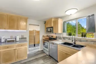 Lovely kitchen with undercabinet lighting & fun saloon doors to laundry room.