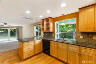 Handsome slab granite counters, undermount sink and updated, full height tile backsplash