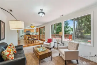 Cozy family room with oversized windows overlooking backyard