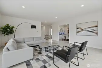 The virtually staged living room opens up to the dinning room
