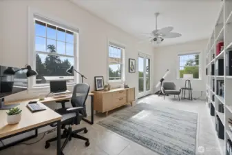 This huge virtually staged office has tons of windows for natural light