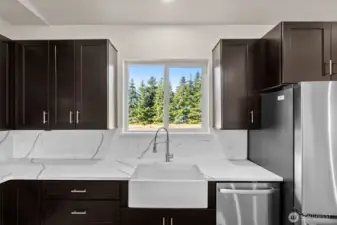 Porcelain farm sink, with view of private, spacious backyard!