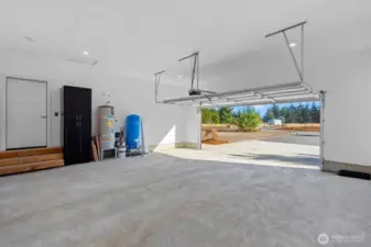 Large finished garage with storage and utility equipment.