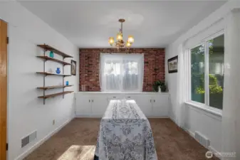 Dining room off of kitchen with beautiful built in cabinetry and large windows making it a light and bright space..