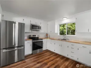 Newly renovated kitchen featuring brand new stainless steel appliances