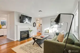 Custom built-ins next to the cozy wood-burning fireplace. Attached TV included in sale.