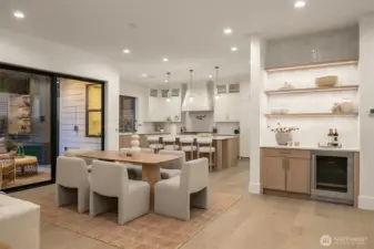 Dining + Wet Bar. An elegant dining area with adjacent wet bar creates a perfect setting for entertaining, seamlessly connected to the great room and kitchen.