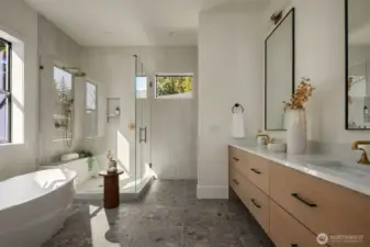 The spa-inspired primary bath features a sophisticated five-piece design with heated floors, delivering everyday luxury and relaxation.