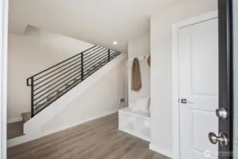 Imagine that....a front foyer!  Features include 2 storage closets, a built in bench with storage, hanging hooks and lots of space to add your personal art and furniture.