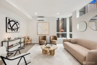 Large living room with a lot of natural light.  No interior units means no dark spaces!  The living room is large enough for sectionals and entertainment sized televisions.  This is a picture of a previous Avenue Plan model home.  We no longer have this plan available, but the living rooms and kitchens are the same size in our last 2 Courtyard plan homes.