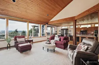 Large windows, with electric blinds, looking to the mountains and view of the Cultus Bay.