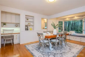 Love the built-in desk with shelves & cabinetry, the recessed shelves and the Dutch door into the large Laundry/Mud Room. Notice the storage cabinets under the bay window seating.